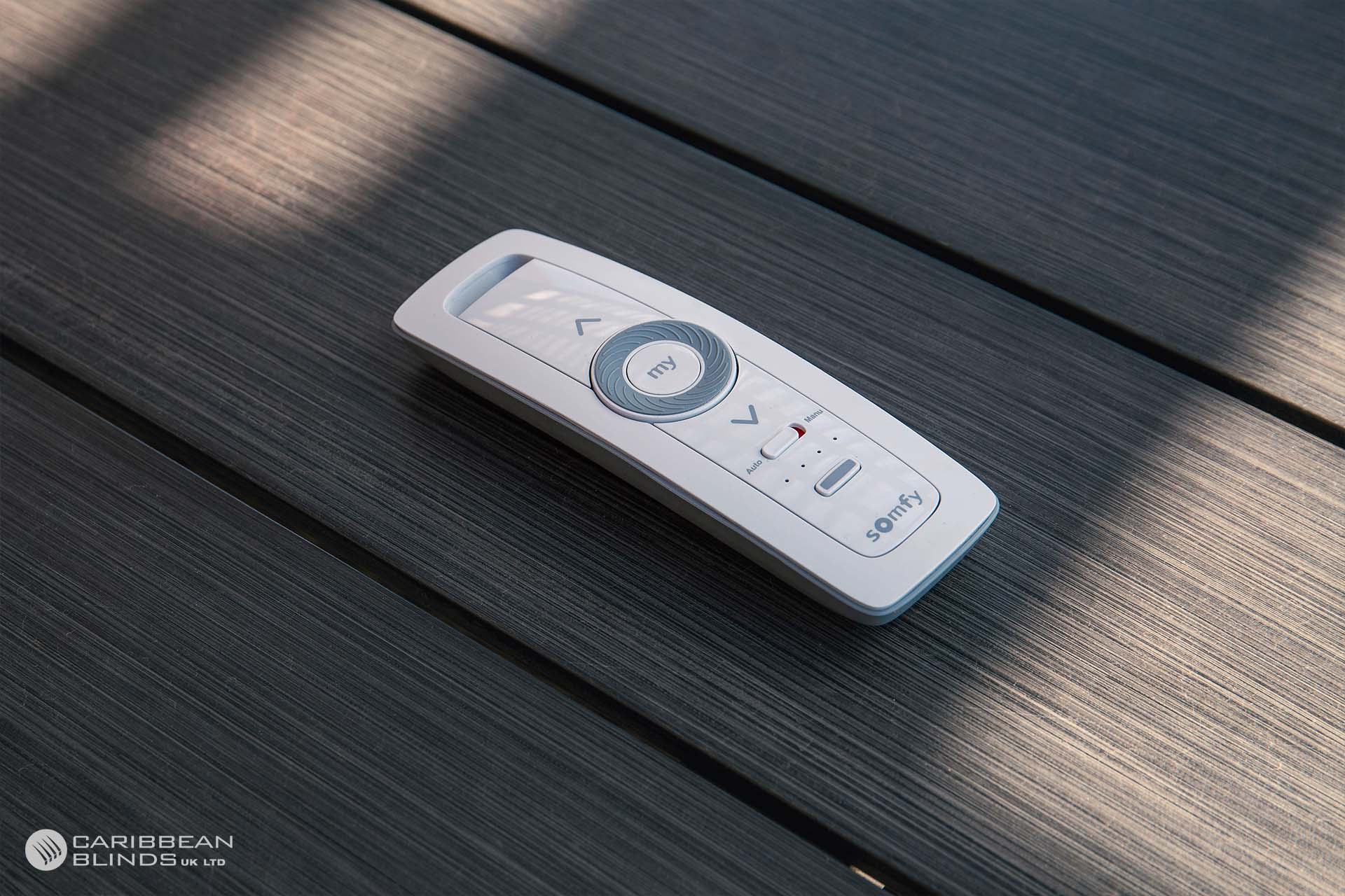 Motorised external blind extended over a patio with remote control