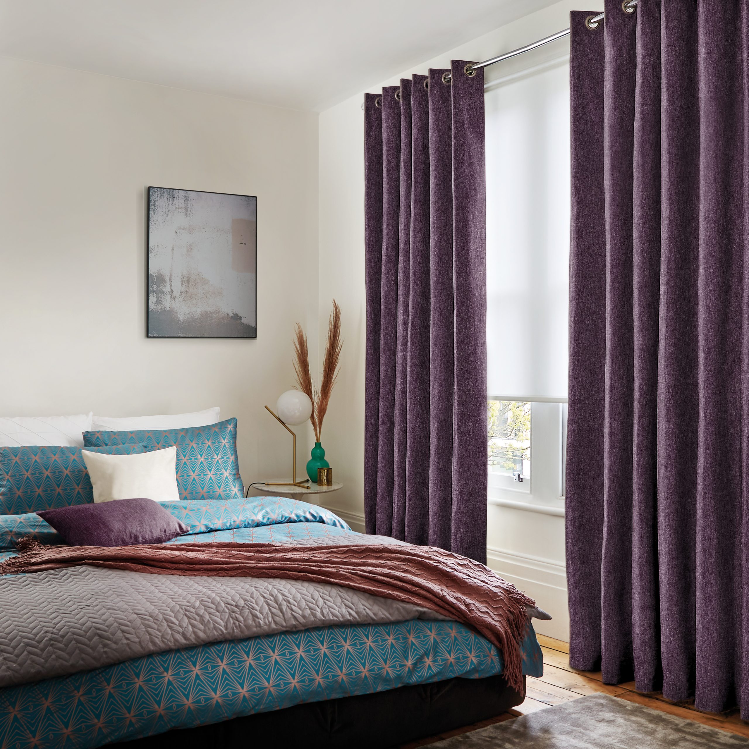 Purple eyelet curtains in a bedroom